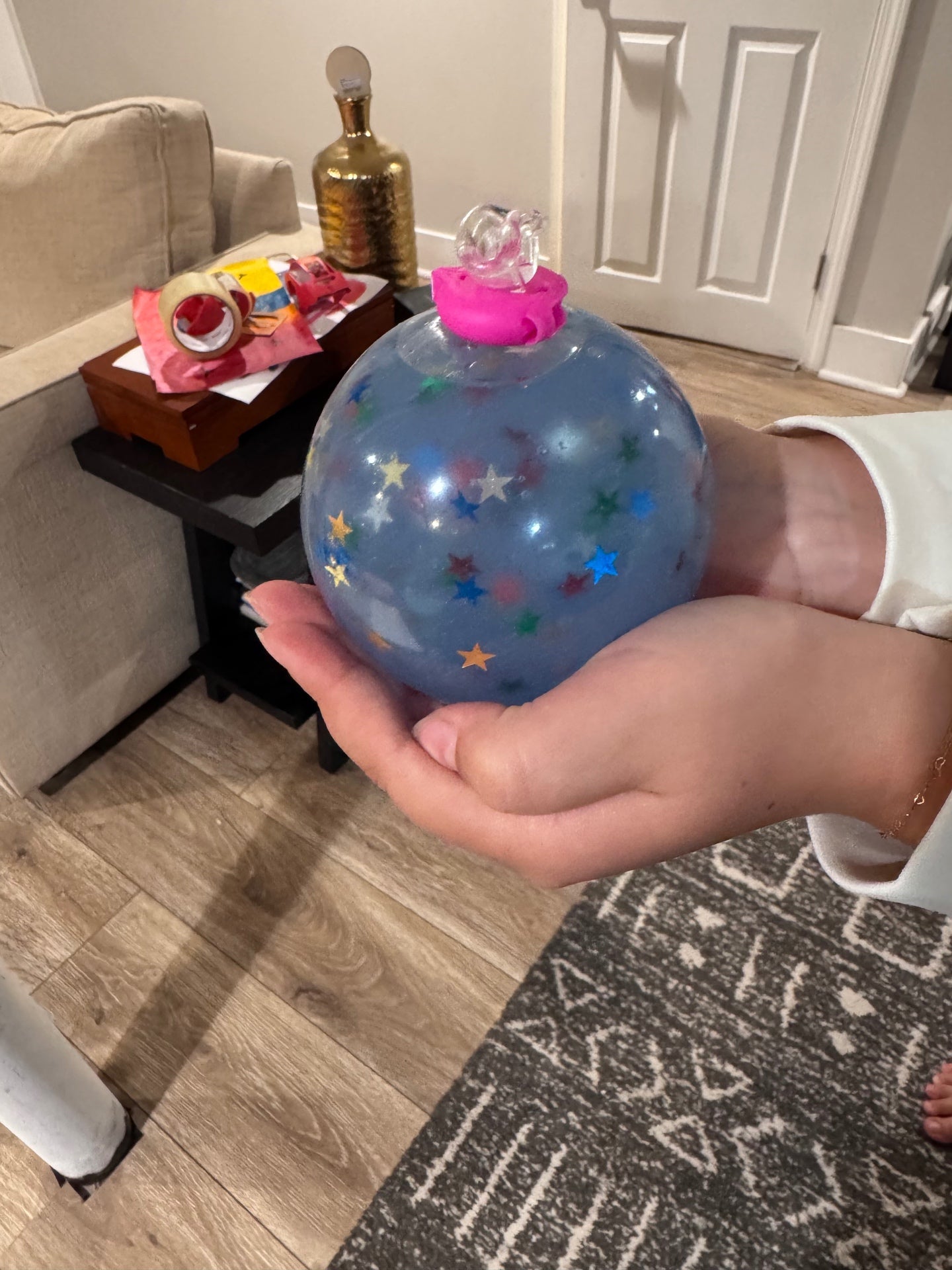 Madison holding a large blue jelly Mad Squish filled with colorful star confetti