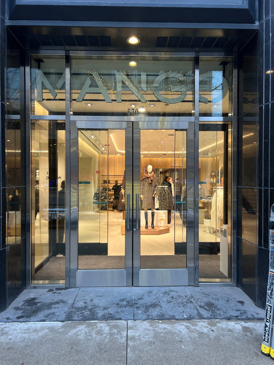 Kawneer aluminum storefront install — Mango by Chicago Glass Company